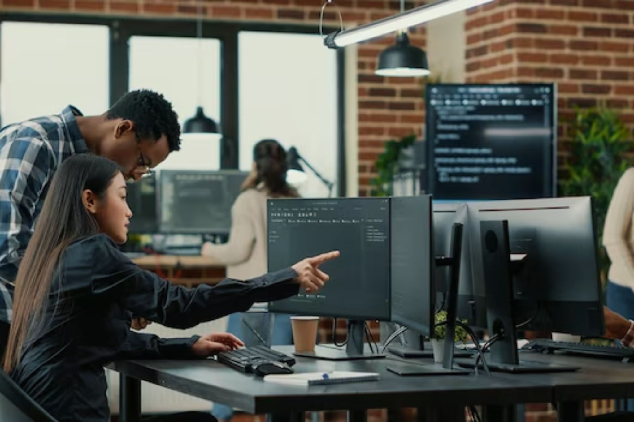 people putting together a website design on a table